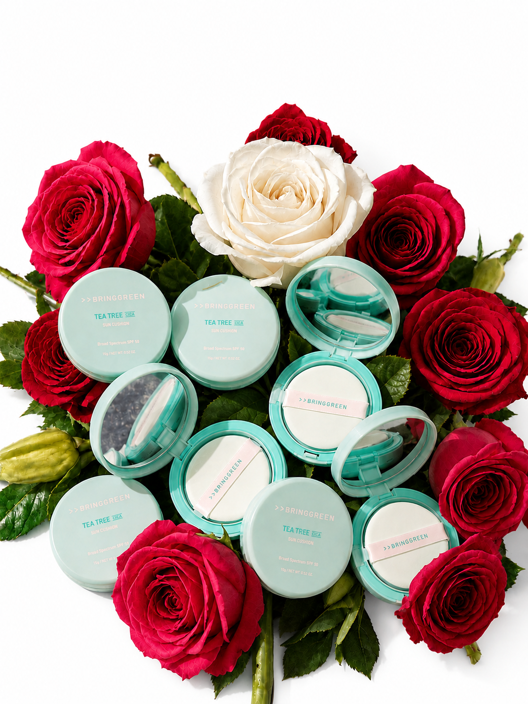 Bring Green Tea Tree Cica Sun Cushion open compacts displayed with roses - lifestyle product shot