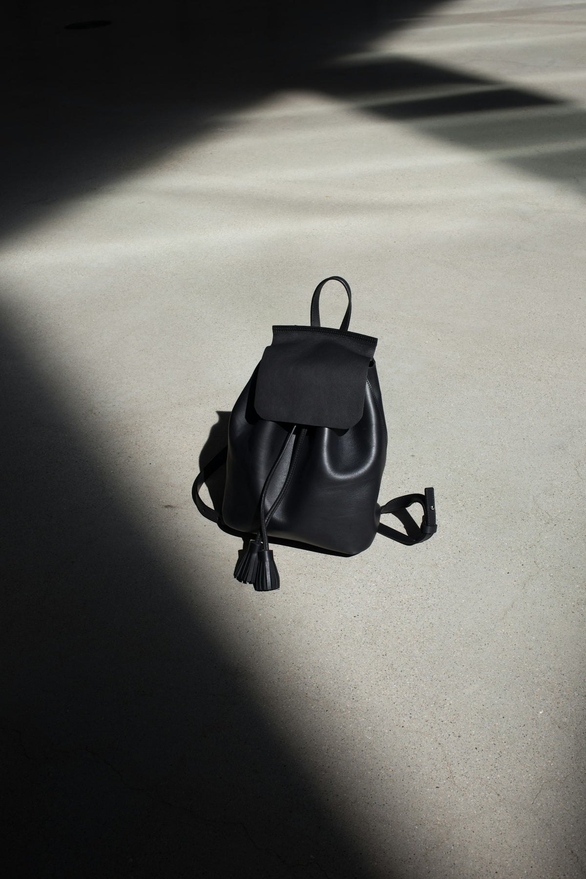 Black leather mini backpack with drawstring