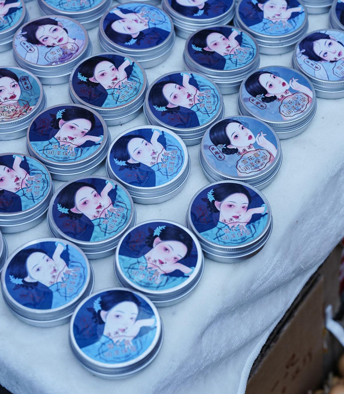 Round tins with illustrated lids
